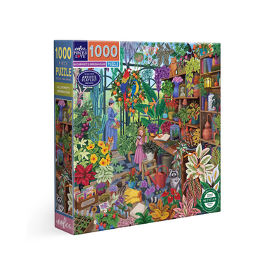 An image of a 1000 piece puzzle box set against a white background. The puzzle is of a vibrant greenhouse overflowing with plants, books, seeds, and birds! 