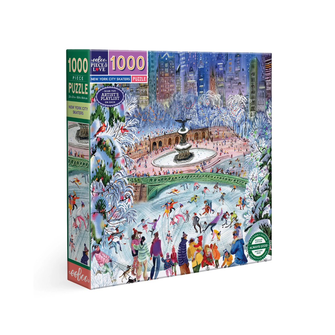 an image of a 1000 piece puzzle box set against an all white background. The puzzle is an image of skaters ice skating in a park with the new York skyline in the background. The image is framed by evergreen trees covered in snow! 