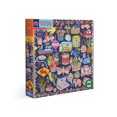 An image of a 1000 piece puzzle box set against a white background. The Puzzle image is a solid blue background with lots of little images covering the blue. the images are things like a drum with red birds on the edge, a basket of flowers, a box of chocolates, a steam boat ship, birds, veggies, and so on. Its cozy and cute!
