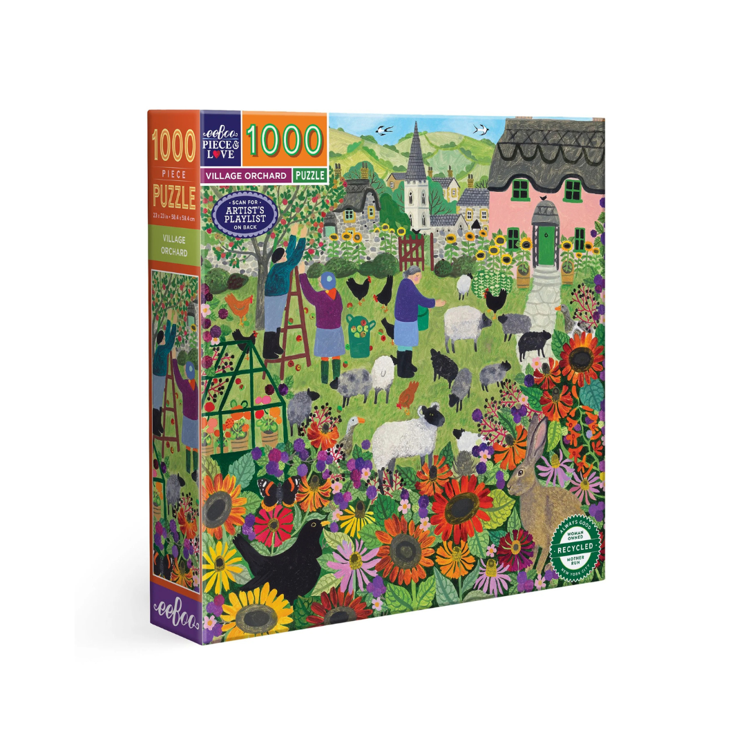 An image of a 1000 piece puzzle box against a white background. The Puzzle is an artists image of a green orchard with flowers, chickens, sheep, and a pink cottage. The puzzle has cozy autumn vibes!
