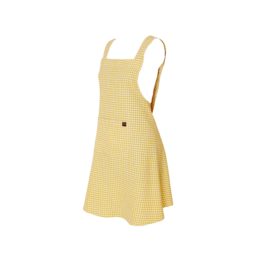 white background with a yellow gingham linen/cotton Apron. 