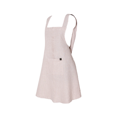 an Image of a light pink gingham linen-cotton blend apron on a white background. 